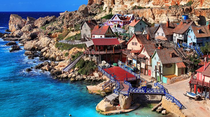 Film set from the 1980 musical 'Popeye', now a theme park village with boat rides & food outlets.