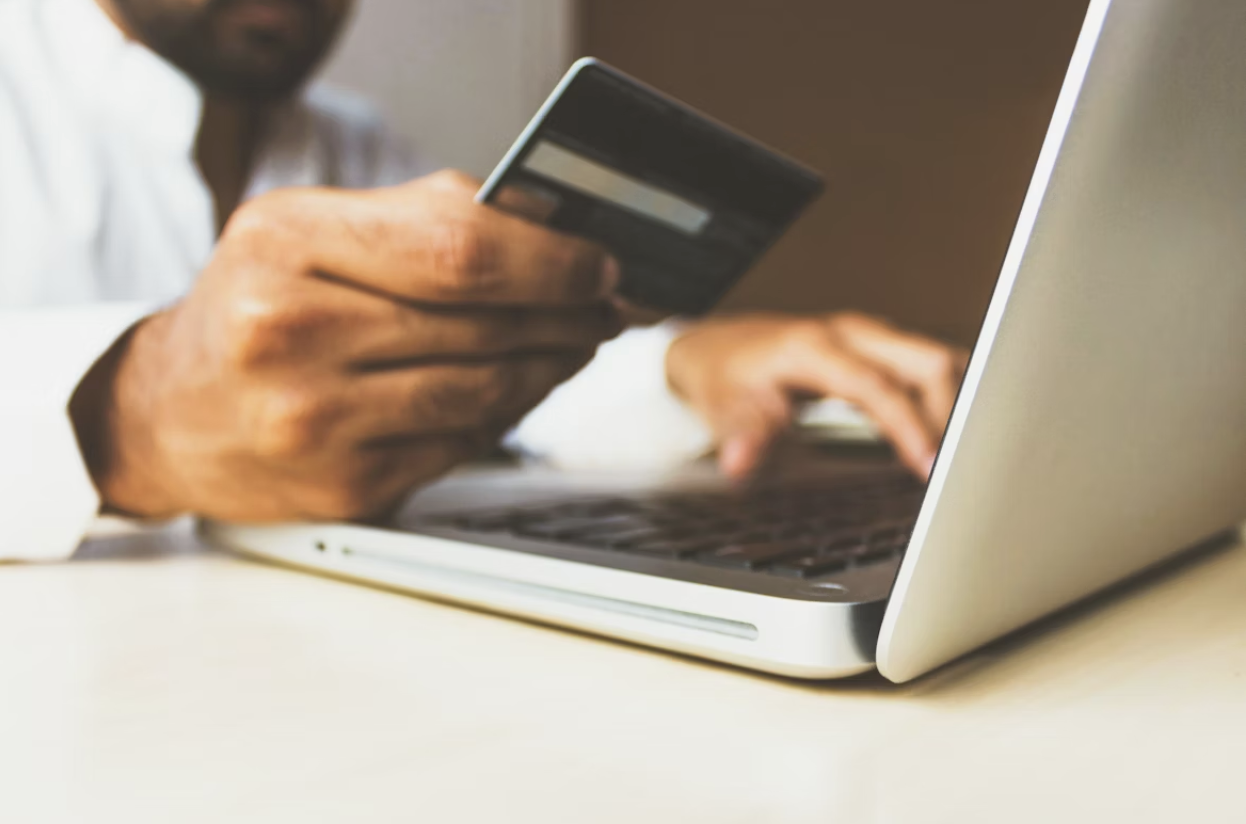 https://unsplash.com/photos/person-using-laptop-computer-holding-card-Q59HmzK38eQ